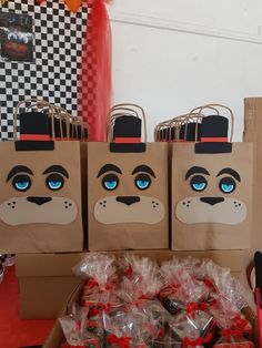 three bags with blue eyes are sitting on a table next to some candy and candies