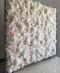 a wall made out of pink and white flowers