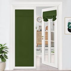 an open door with green curtains and potted plant in the corner next to it