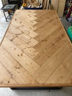 a wooden table top sitting in a garage