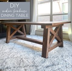 a wooden table sitting on top of a rug in front of a window with the words diy modern farmhouse dining table