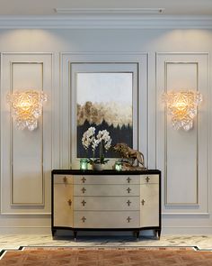 an elegant dresser with two lamps on it in the middle of a room that has white walls and flooring