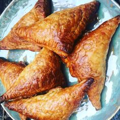 four pieces of pastries on a plate