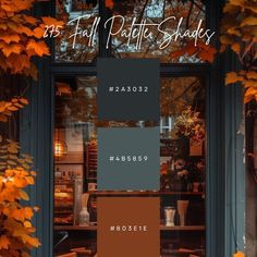 the front door of a store with fall foliage on it and an orange color scheme