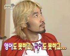 a man with blonde hair wearing a red cape