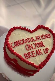 a heart shaped cake that says congratulations on your break up