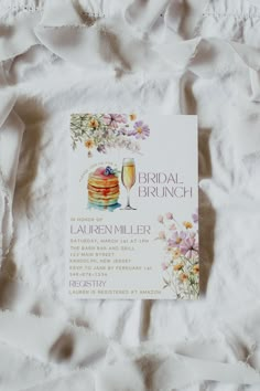 a bridal brunch menu on a bed sheet