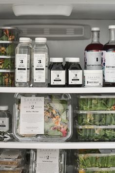 an open refrigerator filled with lots of different types of juices and condiments