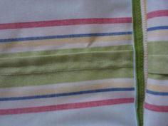 the zipper is open and there are many different colors on this striped shirt that has been stitched together