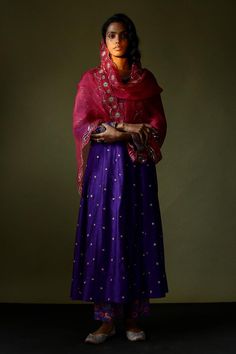 Purple silk anarkali with sequin and zari embroidery. Paired with a velvet embroidered jacket, printed pant and scallop trimmed embroidered pink dupatta.
Components: 4
Pattern: Embroidered
Type Of Work: Hand embroidery
Neckline: Round
Sleeve Type: Long
Fabric: Silk
Color: Purple
Other Details: 
Attached lining
Approx. product weight: 800 gms
Length:
Anarkali: 45 inches
Pant: 38 inches
Closure:
Pant: Elastic
Occasion: Mehendi and Haldi - Aza Fashions Embroidery Neckline, Pink Dupatta, Silk Anarkali, Zari Embroidery, Purple Silk, Embroidered Jacket, Fabric Silk, Pant Set, Embroidered Silk