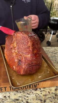 a large piece of meat sitting on top of a wooden cutting board