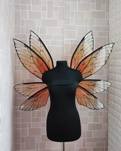 a black mannequin with a butterfly wings on it