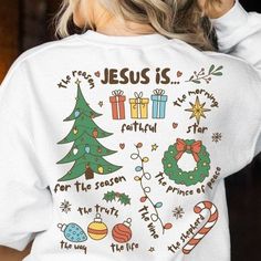 the back of a woman's white jesus is natural christmas t - shirt with trees and presents