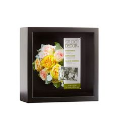 a bouquet of flowers in a black shadow box