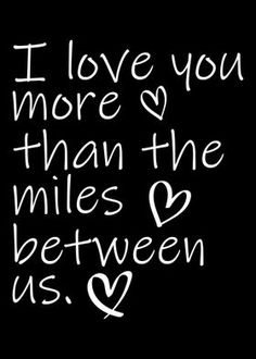 the words i love you more than the miles between us and 2, written in white ink on a black background