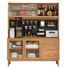 a wooden cabinet with many items on it and bottles in the shelves behind it,