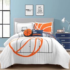 a bed with an orange and white basketball comforter