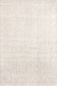 a white rug with an arrow pattern on the top and bottom, in front of a gray background