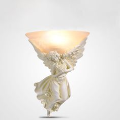 an angel holding a lamp on its back