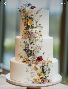 a white wedding cake with flowers on it