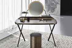 a desk with a mirror and other items on it