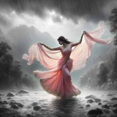 a woman is dancing in the rain with her flowing pink dress and shawl over her head