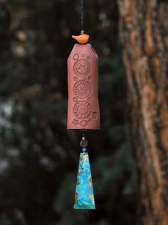 a bird feeder hanging from the side of a tree