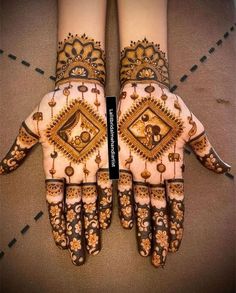 two hands with henna designs on them