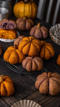 several small pumpkins and other pastries on a table