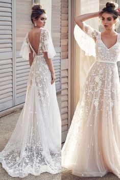 the back of a wedding dress with sheer sleeves and floral appliques on it