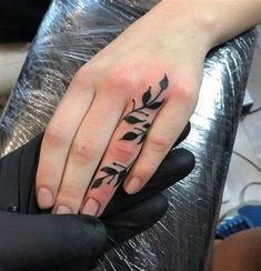 a woman's hand with a tattoo on it