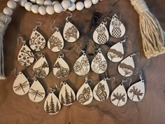 a collection of wooden earrings with different designs on them