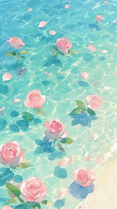 some pink roses floating in the water on a beach