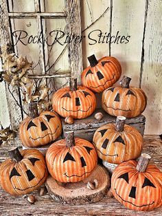 a pile of pumpkins sitting on top of a wooden table