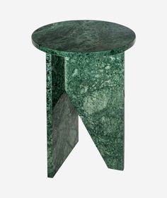 a green marble side table with an irregular design