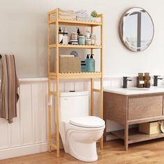 a white toilet sitting next to a wooden shelf filled with bathroom items on top of it