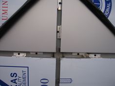 two large white boxes stacked on top of each other with blue and white signs behind them