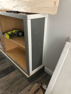 an unfinished cabinet is shown with tools in it