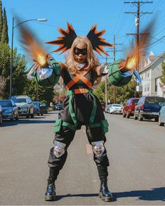 a woman in costume standing on the street with her arms out and two hands outstretched