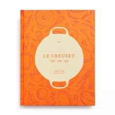 an orange notebook with the words le creuset on it