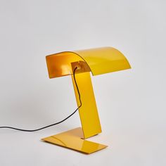 a yellow lamp with a black cord attached to it