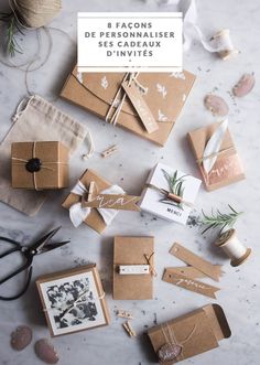 some brown boxes are sitting on a table with scissors and other items around them,