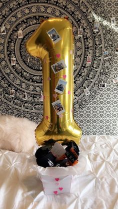 a number one balloon sitting on top of a bed