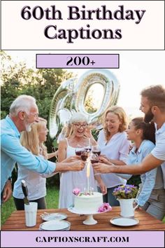 a group of people standing around a table with a cake and wine glasses on it