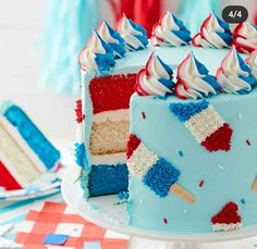 a red, white and blue ice pop cake on a plate with stars around it