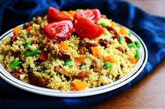 a white plate topped with rice and veggies