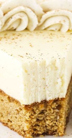 a piece of cake with white frosting on it sitting on top of a plate