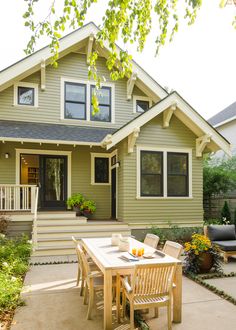 a table and chairs in front of a house