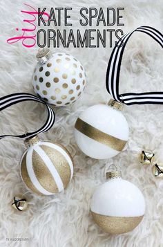 three white and gold christmas ornaments laying on fur