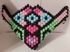 This listing is for ONE (1) pastel wings kandi mask. The mask is made with clear 0.3 mm fluorocarbon monofilament fishing line and plastic 9x6 mm barrel pony beads. If you choose to add beaded earloops, those are made with rainbow elastic 1 mm cord and plastic 9x6 mm barrel pony beads. Elastic mask loops are made of cloth-covered elastic with rubber size adjusters. SPECS: Height, from HIGHEST POINT to BOTTOM POINT: 13 cm Width, at WIDEST TWO SIDES of wings (near top): 21.5 cm If you do not make use of the personalization box, I'll just use the default colors! If you'd like something different but don't have a particular color pattern in mind, just put "random" in the box and I'll throw something that's (hopefully) cute together! Let me know if you want me to check in with you during the cr Kandi Mask, Mask Patterns, Costume Masks, My Workspace, Cat Hair, Fishing Line, Pony Beads, Dog Hair, Costume Accessories